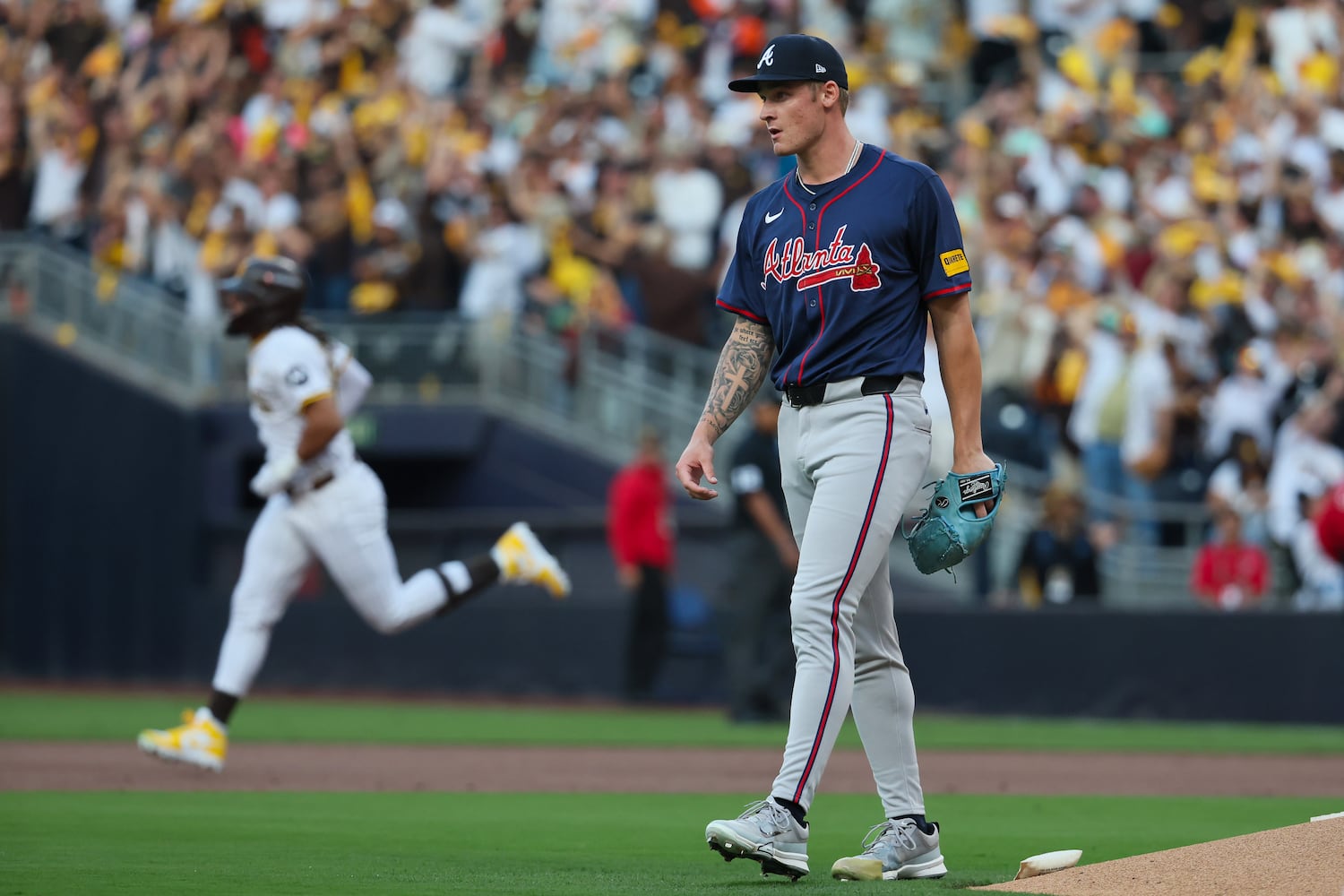 Atlanta Braves pitcher AJ Smith-Shawver (32) reacts after a 2-RBI home run to San Diego Padres’ Fernando Tatis Jr., left, during the first inning of National League Division Series Wild Card Game One at Petco Park in San Diego on Tuesday, Oct. 1, 2024.   (Jason Getz / Jason.Getz@ajc.com)