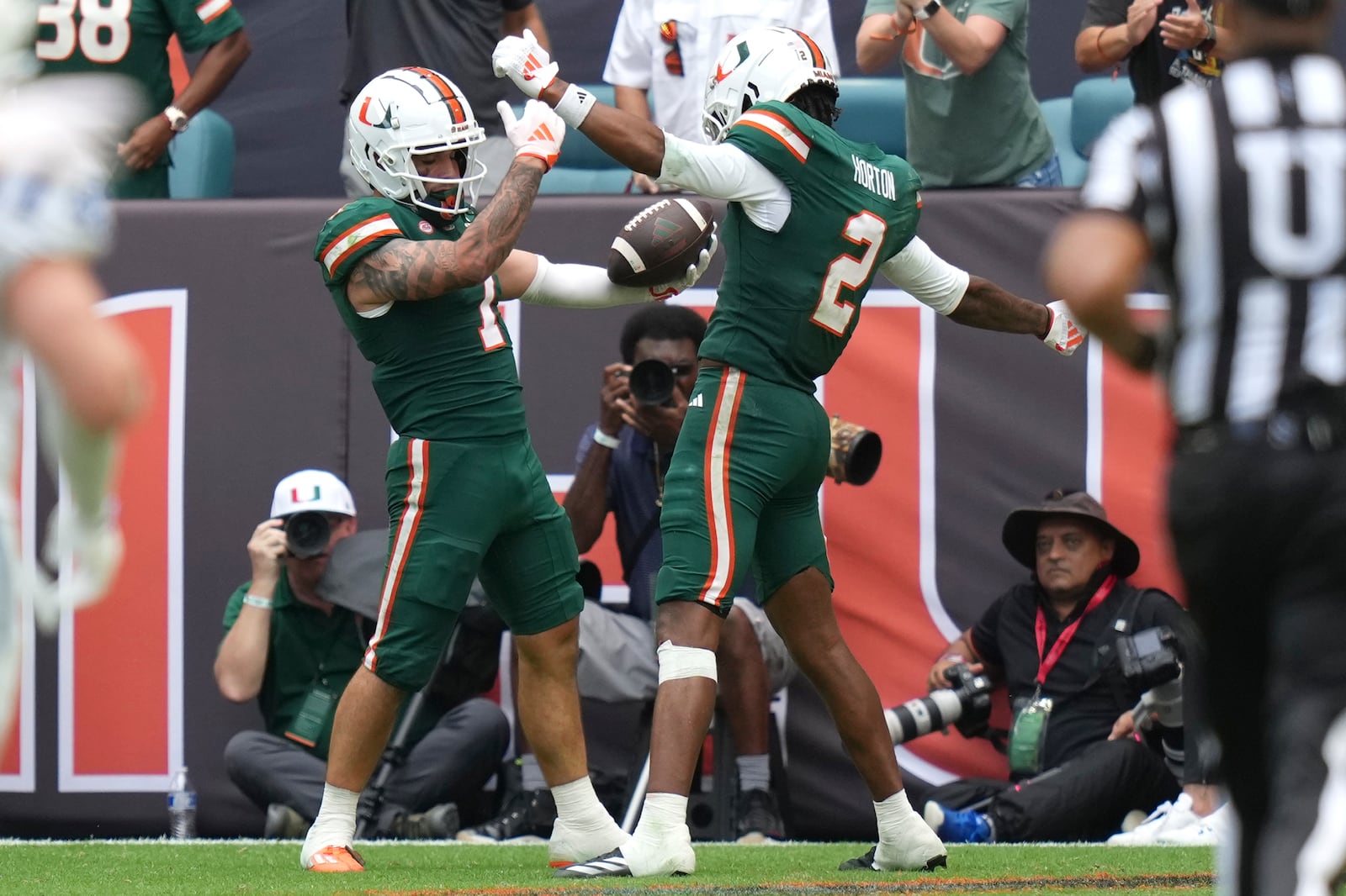 Miami wide receiver Xavier Restrepo, left, celebrates with wide receiver Isaiah Horton (2) after scoring a touchdown during the second half of an NCAA college football game against Duke, Saturday, Nov. 2, 2024, in Miami Gardens, Fla. (AP Photo/Lynne Sladky)