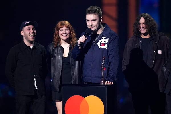 Sam Fender, centre, accepts the best rock/alternative act award during the Brit Awards 2025 in London, Saturday, March. 1, 2025. (Photo by Scott A Garfitt/Invision/AP)