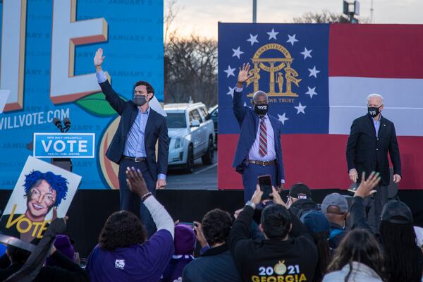 01/04/2021 — Atlanta, Georgia — US Senate Democrat candidates Jon Ossoff (left) and Rev. Raphael Warnock (center) join the stage with President-elect Joe Biden (right) following his remarks during a campaign rally in Atlanta’s Summerhill neighborhood, Monday, January 4, 2021. (Alyssa Pointer / Alyssa.Pointer@ajc.com)