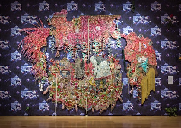 The High Museum acquired this piece by Ebony G. Patterson in 2018. It is called "), …they stood in a time of unknowing...for those who bear/bare witness," and it is described as a "hand-cut jacquard woven photo tapestry with glitter, appliqués, pins, embellishments, fabric, tassels, brooches, acrylic, glass pearls, beads, and hand-cast heliconias." Photo: courtesy High Museum of Art