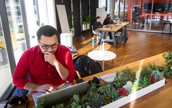 Shopy Live co-founder Juan Cardona (L) works in the common area of the Atlanta Tech Village in Atlanta Thursday Dec. 3, 2020.  STEVE SCHAEFER FOR THE ATLANTA JOURNAL-CONSTITUTION