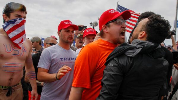 A scuffle breaks out between Pro-Trump and Anti-Trump protesters during Make America Great Again March on March 25, 2017, in Huntington Beach, California. (Photo by Irfan Khan/Los Angeles Times via Getty Images)