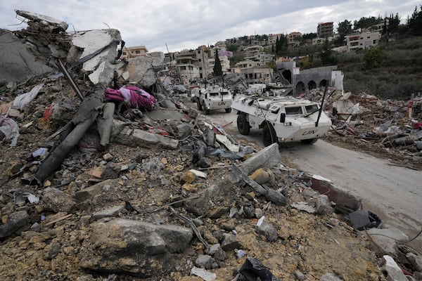 A South Korean U.N peacekeeper patrol drive past destroyed buildings in Chehabiyeh village, southern Lebanon, Thursday, Nov. 28, 2024 following a ceasefire between Israel and Hezbollah that went into effect on Wednesday. (AP Photo/Hussein Malla)