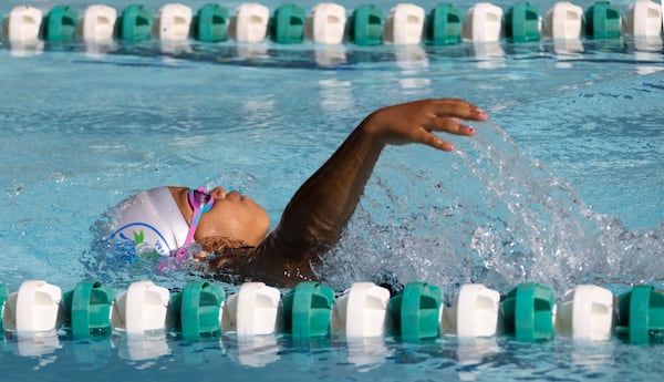 Sanaya McClendon, 8, competes in the backstroke in a swim meet at Leslie Beach Club in Atlanta on Saturday, May 21, 2022.    According to the USA Swimming Foundation, while most Americans learn how to swim during childhood, 64% of Black children in America have little to no swimming ability. (Bob Andres / robert.andres@ajc.com)