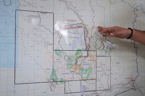 An engineer shows the location of the Cobre Panama copper mine, owned by Canada's First Quantum Minerals, during a press tour of the mine that was closed after Panama's Supreme Court ruled that the government concession was unconstitutional, in Donoso, Panama, Friday, March 21, 2025. (AP Photo/Matias Delacroix)