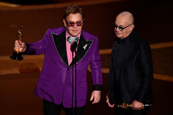 Elton John, left, and Bernie Taupin accept the award for best original song for "(I'm Gonna) Love Me Again" from "Rocketman" at the Oscars on Sunday, Feb. 9, 2020, at the Dolby Theatre in Los Angeles. (AP Photo/Chris Pizzello)