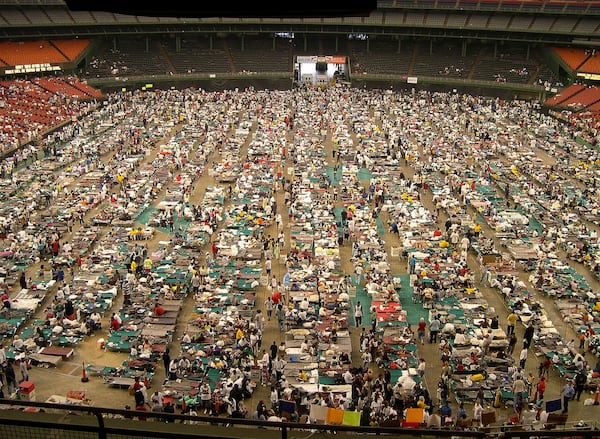 FILE - The floor of Houston's Astrodome is covered with cots and evacuees from hurricane ravaged New Orleans, Sept. 2, 2005. (AP Photo/Pat Sullivan, File)