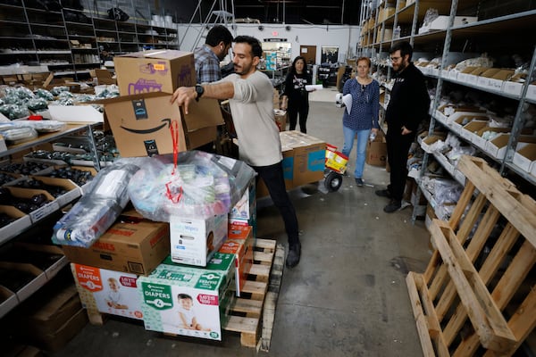 Gokhan Yavuz drops fill a pallet with donations during the Turkey relief drive organized by various organizations of the Turkey community in the metro Atlanta area. Yavuz said that Turkish Airlines would pick up six pallets’ worth of donations daily and transport them to Turkey for free.  Miguel Martinez / miguel.martinezjimenez@ajc.com  