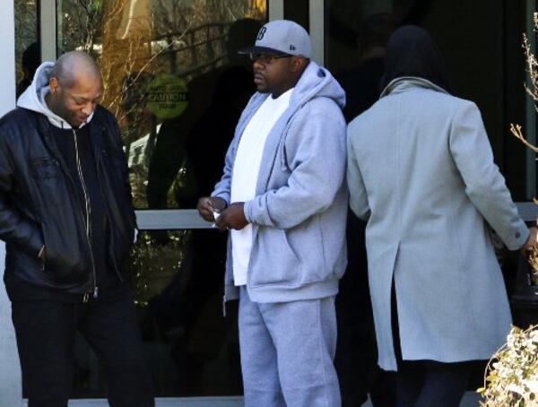 Bobby Brown, center, at Emory University hospital while his daughter Bobbi Kristina was . AP photo/Ron Harris