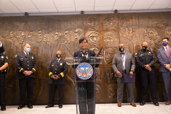 Atlanta Mayor Keisha Lance Bottoms leads a press conference on Aug. 3, 2021, at City Hall to address rising crime, a murder in Piedmont Park, and COVID-19 delta variant concerns. Behind the mayor to her immediate left is Atlanta Police Chief Rodney Bryant. (Jenni Girtman for The Atlanta Journal-Constitution)