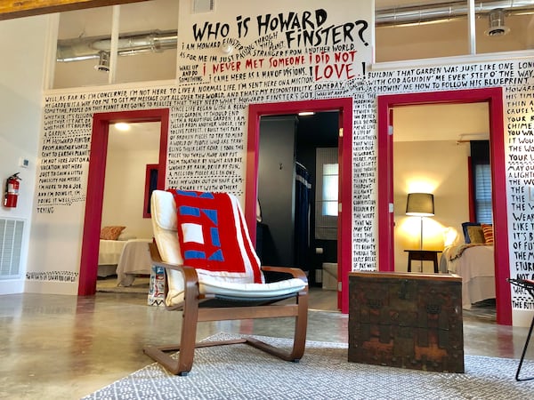 A photo of what's called the bungalow, one of three AirBnb places to stay at Paradise Garden, the four-acre creation of folk artist Howard Finster. The "Who is Howard Finster?" wall was conceived by Atlanta-based interior designer Summer Loftin and displays many of Finster's writings and musings. (Photo courtesy of Paradise Garden Foundation)