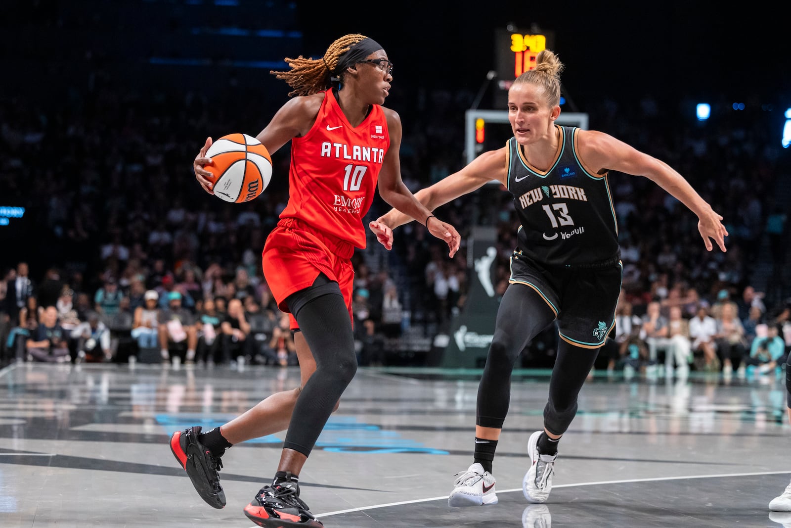 Atlanta Dream guard Rhyne Howard (10) is defended by New York Liberty forward Leonie Fiebich (13) during the second half of a WNBA basketball first-round playoff game Sunday, Sept. 22, 2024, in New York. (AP Photo/Corey Sipkin)