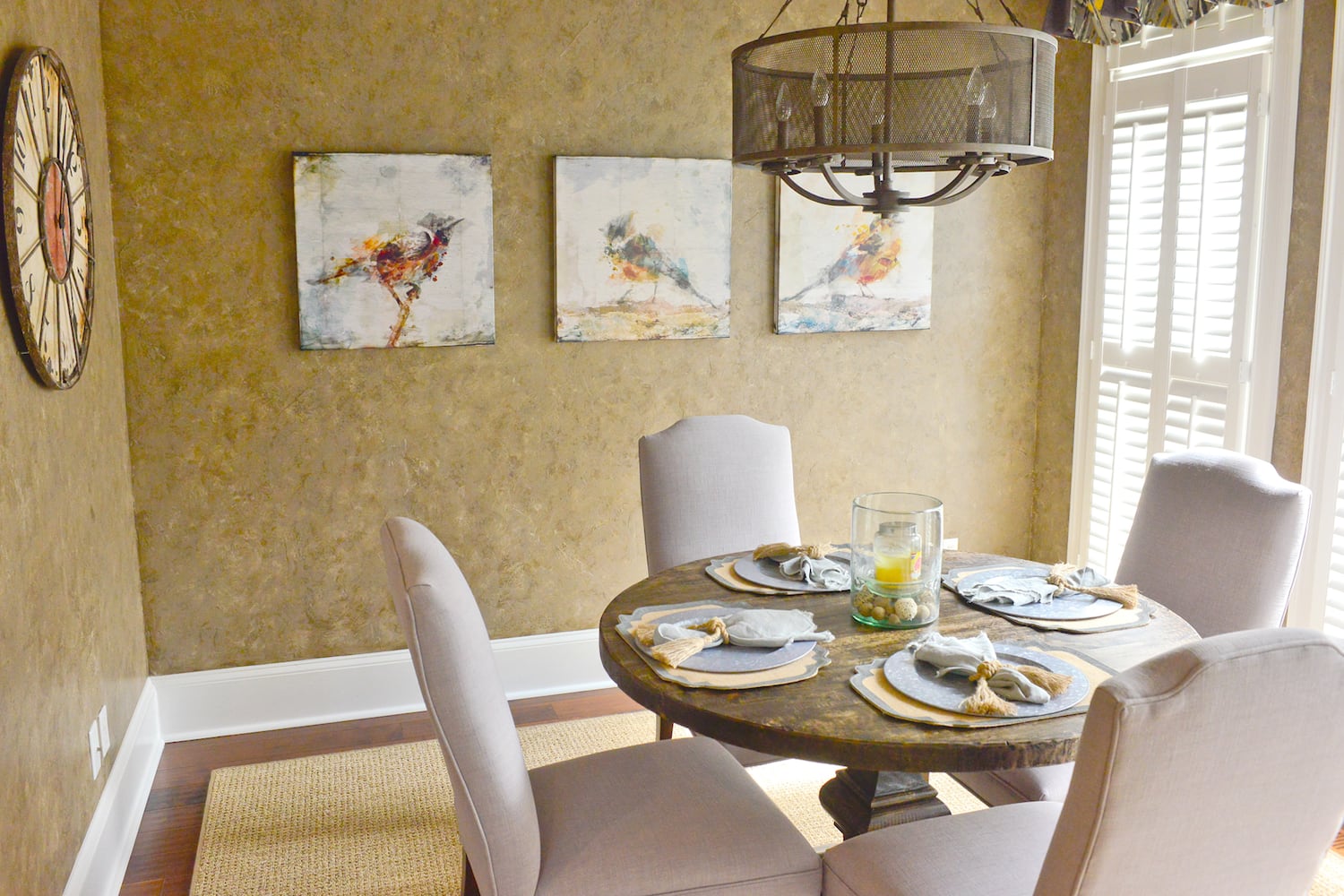 Cozy eating nook just off the kitchen with a five-light pendant