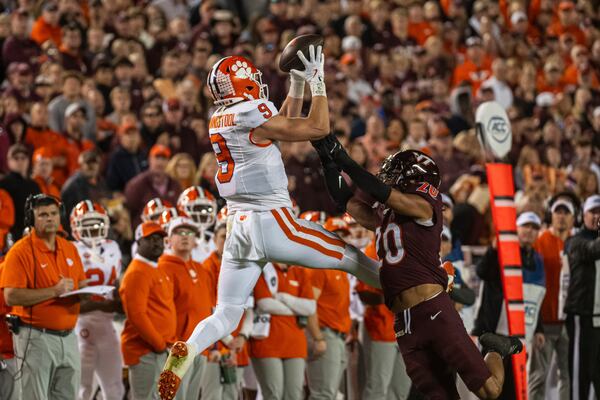 Clemson's Jake Briningstool (9) catches pass against Virginia Tech's Caleb Woodson (20) during the second half of an NCAA college football game Saturday, Nov. 9, 2024, in Blacksburg, Va. (AP Photo/Robert Simmons)