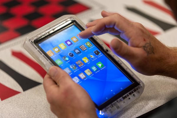 Inmate Dustin Blevins demonstrates using a tablet at Gwinnett County Jail in Lawrenceville on Wednesday, April 26, 2023. (Arvin Temkar / arvin.temkar@ajc.com)