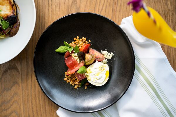 Heirloom Tomato Salad with compressed watermelon, balsamic, burrata, and basil crunch. Photo credit- Mia Yakel.