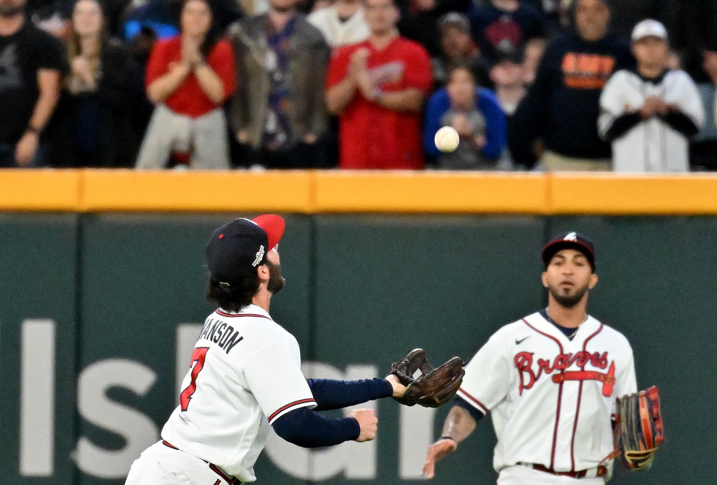 Atlanta Braves shortstop Dansby Swanson (7) makes an over the shoulder catch of the popup by Philadelphia Phillies’ J.T. Realmuto during the sixth inning of game two of the National League Division Series at Truist Park in Atlanta on Wednesday, October 12, 2022. (Hyosub Shin / Hyosub.Shin@ajc.com)