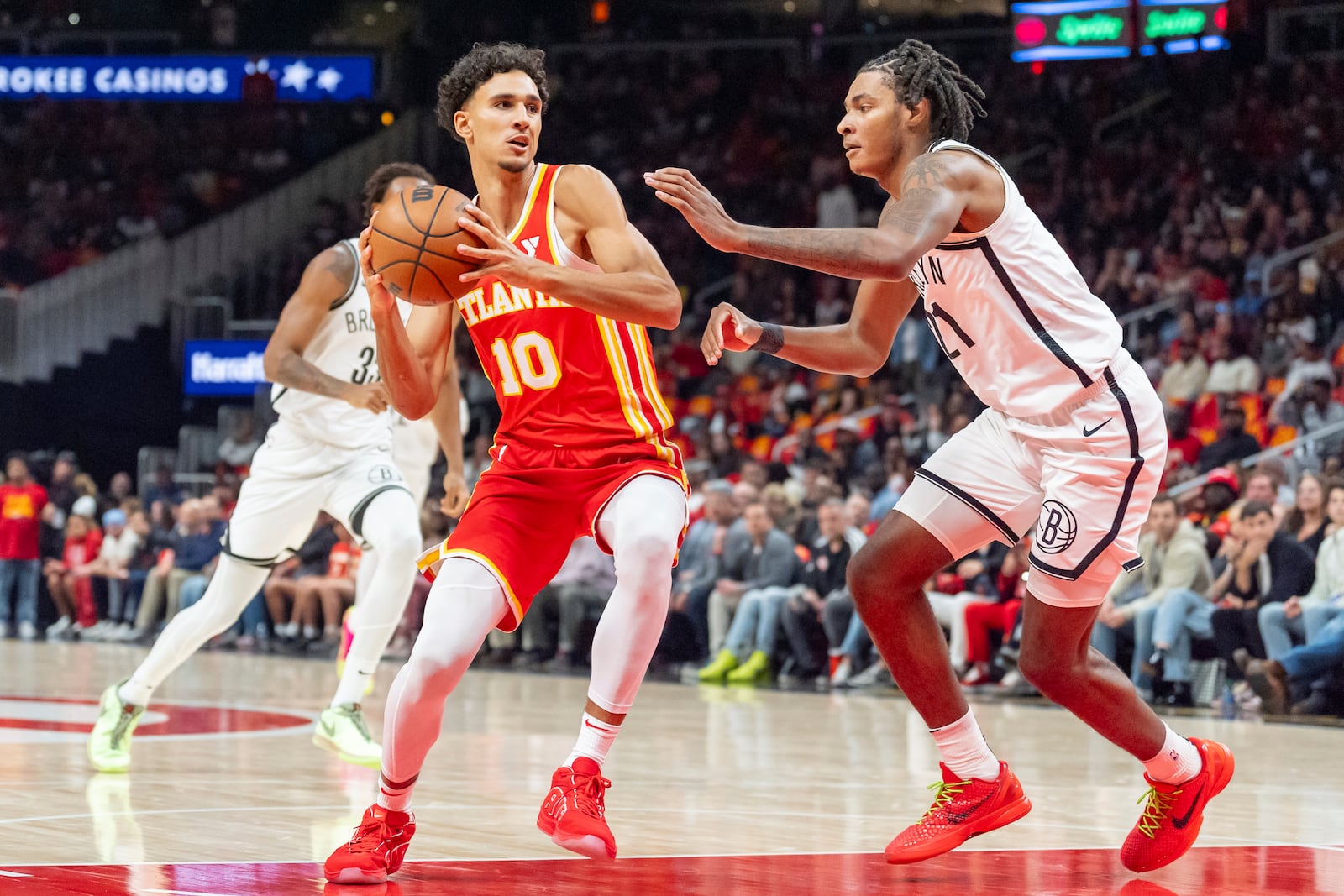 Atlanta Hawks forward Zaccharie Risacher (10) goes up for a layup guarded by Brooklyn Nets forward Noah Clowney (21) during the first half of an NBA basketball game Wednesday, Oct. 23, 2024, in Atlanta. (AP Photo/Jason Allen)