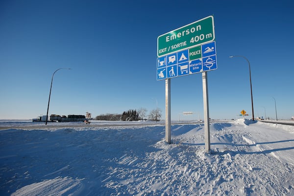 FILE - Road signage is posted just outside of Emerson, Manitoba on Thursday, Jan. 20, 2022. (John Woods/The Canadian Press via AP)