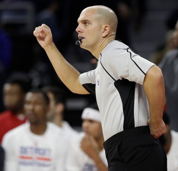 In this Dec. 17, 2016, file photo, referee Jacyn Goble signals during the first half of an NBA basketball game between the Detroit Pistons and the Indiana Pacers in Auburn Hills, Mich. John and Jacyn Goble are the first siblings to be on the NBA's officiating staff at the same time. John is in his 10th season in the league. He encouraged Jacyn to get back into officiating while he worked with the Miami-Dade Police Department, and this season his younger brother was promoted to the NBA's 64-member staff. (AP Photo/Carlos Osorio, File)