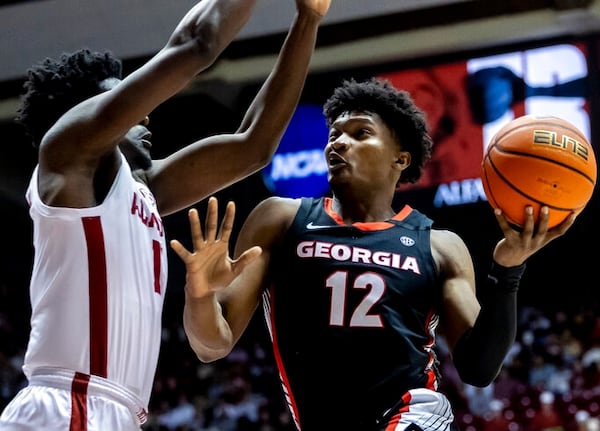 Georgia forward Matthew-Alexander Moncrieffe (12) drives to the basket against Alabama center Charles Bediako (14) during the first half of an NCAA college basketball game Saturday, Feb. 18, 2023, in Tuscaloosa, Ala. (AP Photo/Vasha Hunt)