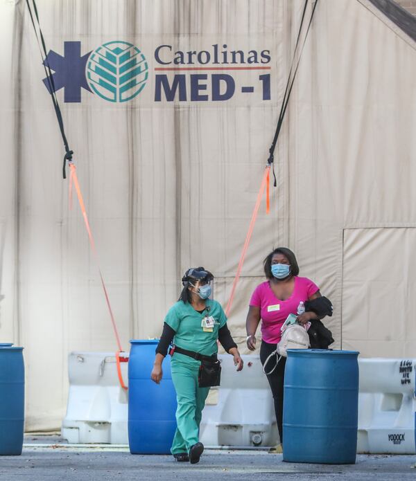 Nov. 20, 2020: Medical workers leave the mobile units outside Grady Memorial Hospital. During the first fall and winter of the pandemic, hospitals across Georgia scrambled to make room for COVID-19 patients and hire more nurses as the state was hit with a wave of new cases. (John Spink / AJC file photo 2020)

