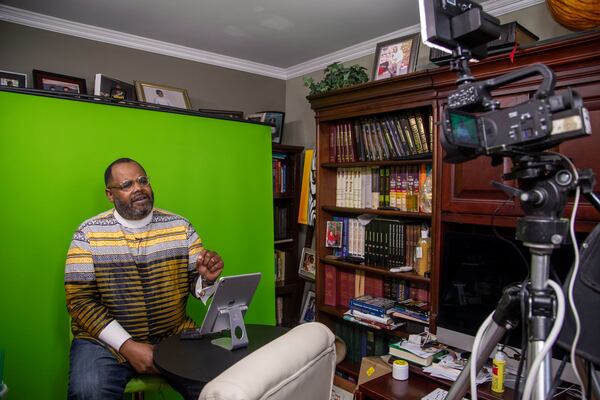 Rev. Darryl Winston records a sermon for his parishioners from his residence in Marietta. He says that offering comforting during the pandemic is especially hard because his faith teaches him to embrace hope, and the pandemic's toll has been relentless. (Alyssa Pointer / Alyssa.Pointer@ajc.com)