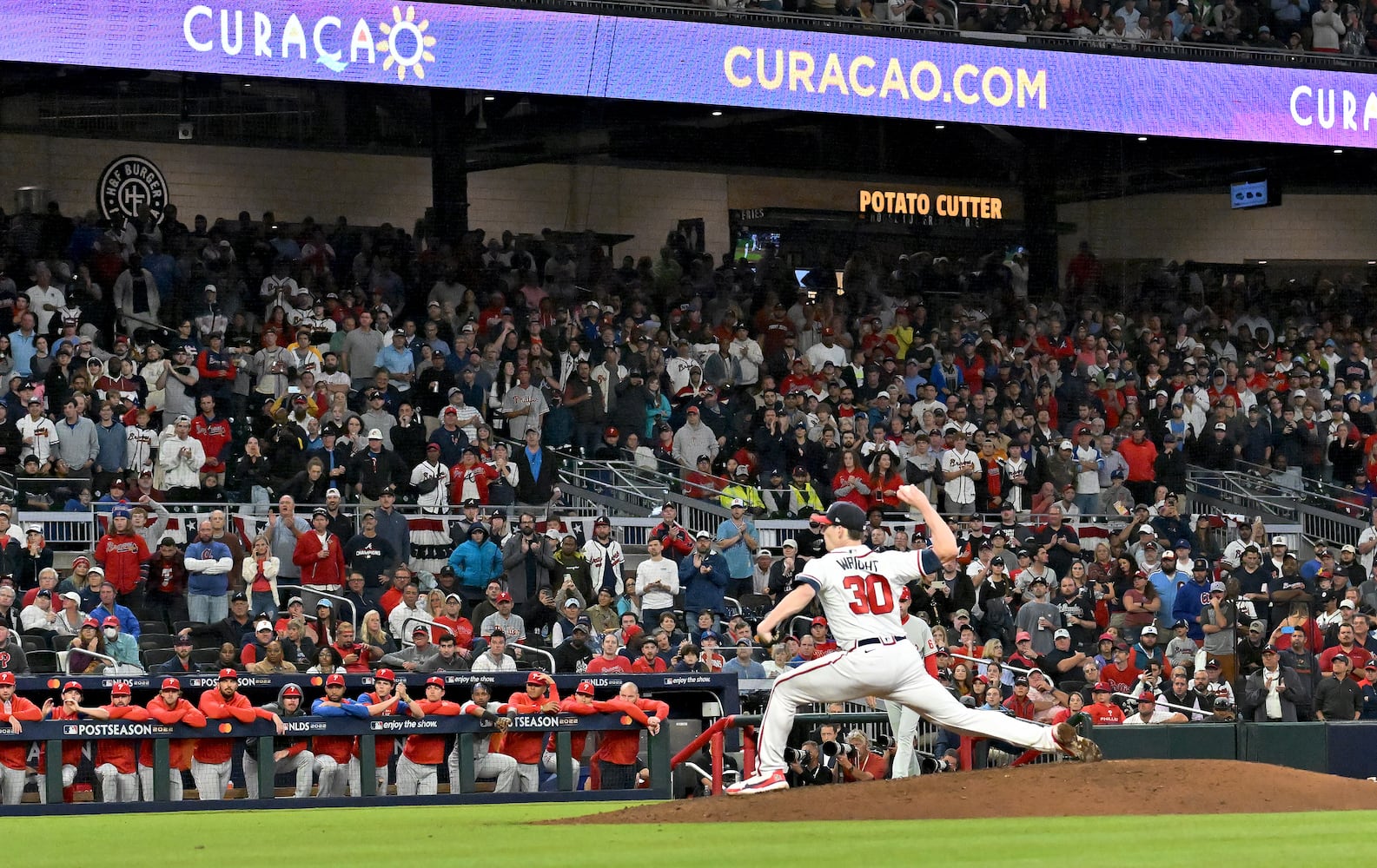 Atlanta Braves starting pitcher Kyle Wright (30) delivers to the Philadelphia Phillies during the sixth inning of game two of the National League Division Series at Truist Park in Atlanta on Wednesday, October 12, 2022. (Hyosub Shin / Hyosub.Shin@ajc.com)