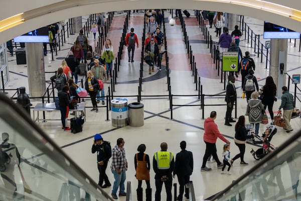 Holiday travelers are seen at Hartsfield-Jackson Atlanta International Airport in Atlanta on Wednesday, November 23, 2022. (Arvin Temkar / arvin.temkar@ajc.com)