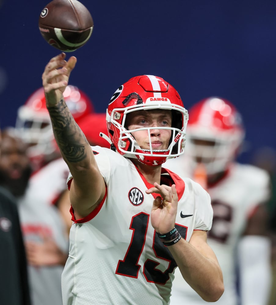 Georgia Bulldogs quarterback Carson Beck (15) warms up before facing the Alabama Crimson Tide during the SEC Championship football game at the Mercedes-Benz Stadium in Atlanta, on Saturday, December 2, 2023. (Jason Getz / Jason.Getz@ajc.com)