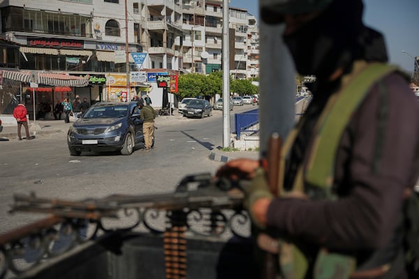 Syrian security forces inspect vehicles at a checkpoint, following a recent wave of violence between Syrian security forces and gunmen loyal to former President Bashar Assad, as well as subsequent sectarian attacks, in Latakia, in Syria's coastal region, Tuesday, March 11, 2025. (AP Photo/Ghaith Alsayed)