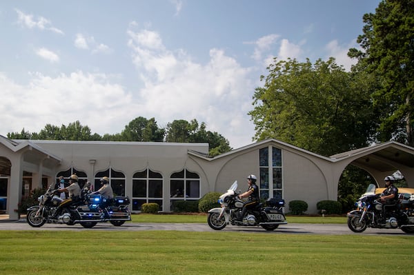 08/07/2020 - Marietta, Georgia - A police motorcade escorts the family go Herman Cain to Alfonso Dawson Mortuary before the start of his funeral service in Atlanta's Harland terrace community, Friday, August 7, 2020. Cain, former Republican presidential candidate, businessman and radio broadcaster, died July 30 at the age of 74. The Henry County resident had been hospitalized for a month with COVID-19 after traveling throughout much of June, including to a rally for his ally President Donald Trump. (ALYSSA POINTER / ALYSSA.POINTER@AJC.COM)