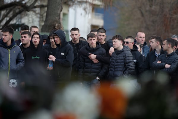 People wait in line to write condolence messages for the victims of a massive nightclub fire in the town of Kocani, North Macedonia, Monday, March 17, 2025. (AP Photo/Boris Grdanoski)