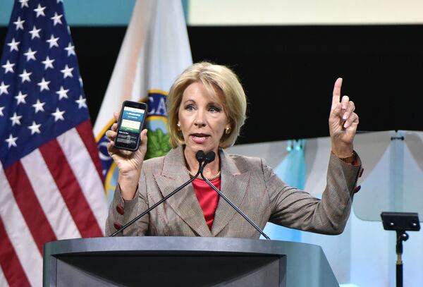 U.S. Education Secretary Betsy DeVos shows FAFSA mobile app as she speaks during 2018 FSA Training Conference at Georgia World Congress Center on Tuesday, November 27, 2018. HYOSUB SHIN / HSHIN@AJC.COM