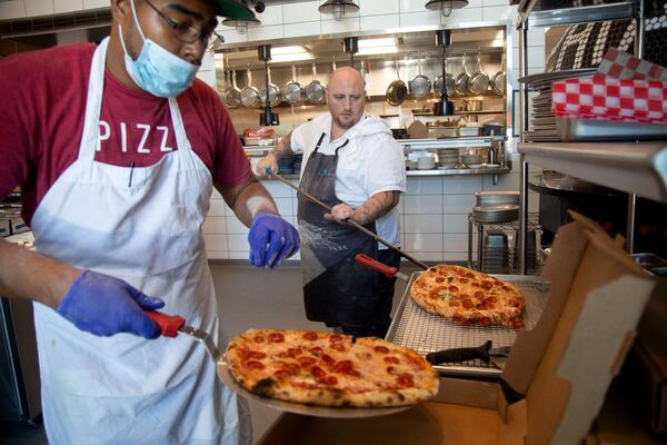 Grana owner Pat Pascarella (right) and Deshayne Edmondson work on a lunch to-go order in Pascarella’s new restaurant in Atlanta, Friday 12, 2020. PHOTO: STEVE SCHAEFER FOR THE ATLANTA JOURNAL-CONSTITUTION