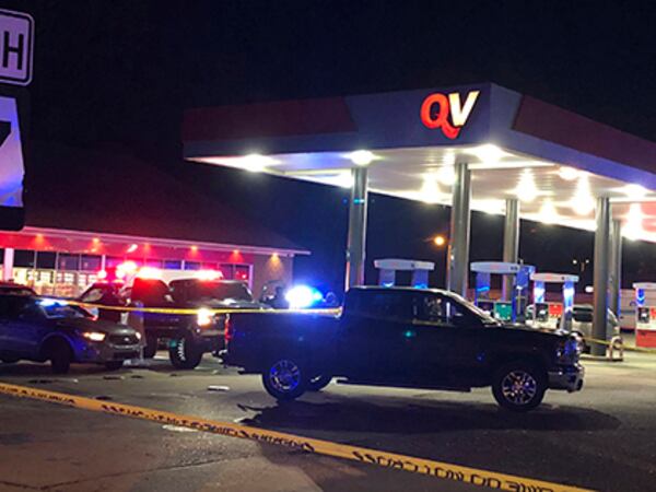 Police process the crime scene after a shooting at a convenience store Saturday in Hayneville, Ala.