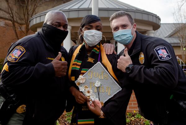 (Left to right) Sgt. Louis Defense, public information officer for the Smyrna Police Department, Miaja Jefferson, former intern with the Smyrna Police Department, and Officer Taylor Elliot, police officer with the Smyrna Police Department, pose for a portrait on Thursday,  December 17, 2020, at the Smyrna Police Department headquarters in Smyrna, Georgia. Jefferson overcame the personal challenges of having a child and being in fostercare as a teenager to earn her bachelor's degree in criminal justice from Kennesaw State University.  She is in the process of applying to be a Cobb County police officer and hopes to eventually become an FBI agent. CHRISTINA MATACOTTA FOR THE ATLANTA JOURNAL-CONSTITUTION.  