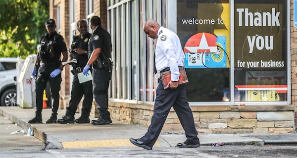 Atlanta police Deputy Chief Charles Hampton Jr. (center) was on the scene of a deadly stabbing Monday morning at a southwest Atlanta Texaco.