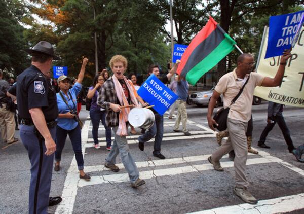 Capitol police officer monitors hundreds of protesters marching to the Georgia State Capitol in Atlanta to protest against the execution of Troy Anthony Davis on Tuesday.