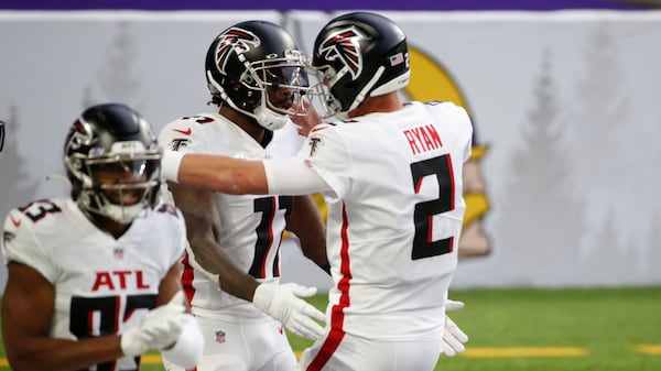 Atlanta Falcons wide receiver Julio Jones, left, celebrates with quarterback Matt Ryan (2) after catching a 20-yard touchdown pass during the first half against the Minnesota Vikings, Sunday, Oct. 18, 2020, in Minneapolis. (Bruce Kluckhohn/AP)