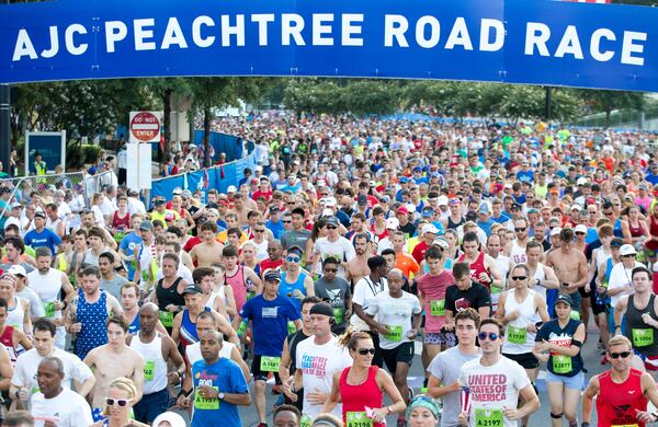 Runners cross the starting line during the 48th AJC Peachtree Road Race, Tuesday, July 4, 2017, in Atlanta.   BRANDEN CAMP/SPECIAL