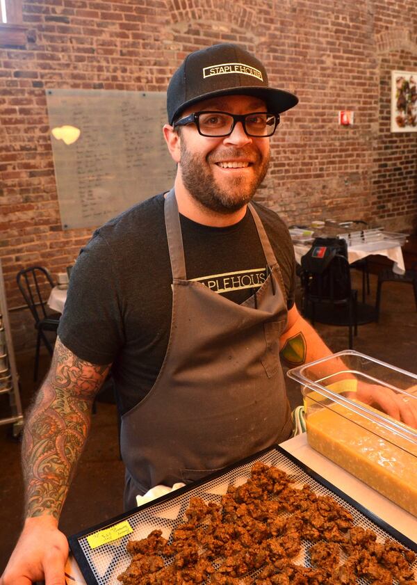 Chef Ryan Smith of Staplehouse pauses for a moment while working with a fermented barley Koji. Contributed by Chris Hunt