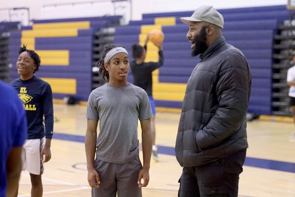 Eagles Landing High School sophomore Christian Spencer talks with JV basketball coach Eric Wortham during practice, Wednesday, December 21, 2022, in McDonough, Ga.. Spencer, who has autism, overcame the odds to earn a spot on the Eagle’s Landing JV basketball team. (Jason Getz / Jason.Getz@ajc.com)