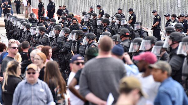 Police form a cordon separating counter-protesters from a National Socialist Movement rally at Greenville Street Park in downtown Newnan on Saturday, April 21, 2018. HYOSUB SHIN / HSHIN@AJC.COM