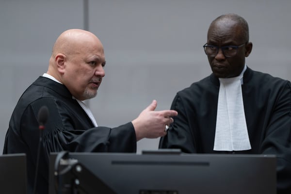 Chief Prosecutor Karim Khan, left, talks to Deputy Prosecutor Mame Mandiaye Niang as they wait for former Philippine President Rodrigo Duterte to appear via video link before the International Criminal Court (ICC) in The Hague, Netherlands, Friday, March 14, 2025. (AP Photo/Peter Dejong, Pool)