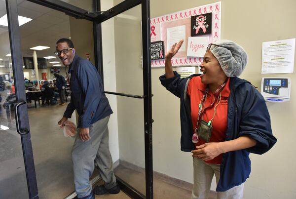 Byron Ferguson (left) jokes with Keita Singleton, training coordinator, in the break room at Alatrade Foods, where Ferguson works, in Phoenix City, Ala.