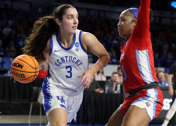 Kentucky's Georgia Amoore (3) drives around Liberty's Jordan Hodges, right, during the first half in the first round of the NCAA college basketball tournament in Lexington, Ky., Friday, March 21, 2025. (AP Photo/James Crisp)