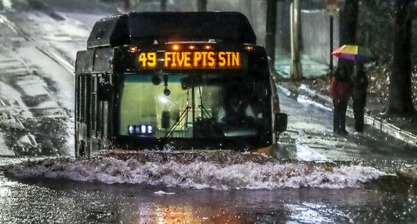 Near Turner Field, a MARTA bus trudged through standing water along Pollard Boulevard on Wednesday morning, January 4, 2023. (John Spink / John.Spink@ajc.com)

