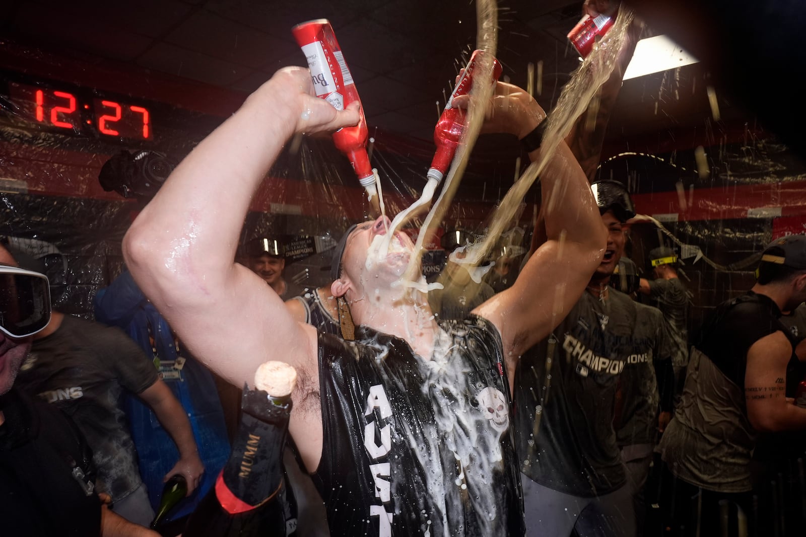 New York Yankees' Tommy Kahnle celebrates in the clubhouse after Game 5 of the baseball AL Championship Series against the Cleveland Guardians Sunday, Oct. 20, 2024, in Cleveland. The Yankees won 5-2 to advance to the World Series. (AP Photo/Godofredo A. Vásquez )